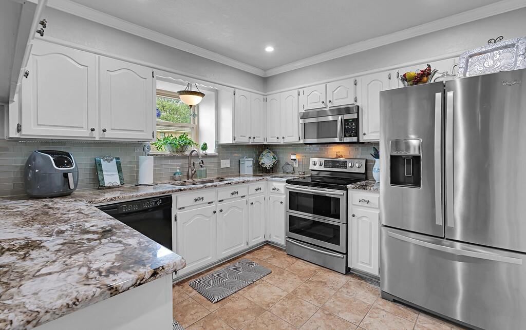 1065 Dendron Drive Hewitt, TX 76643 - Photo 9 of 32 a kitchen with stainless steel appliances granite countertop a refrigerator sink and stove
