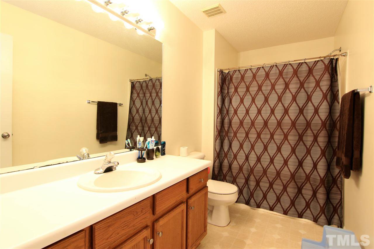364 Rosa Circle Willow Spring, NC 27592 - Photo 14 of 21 a bathroom with a sink and a mirror