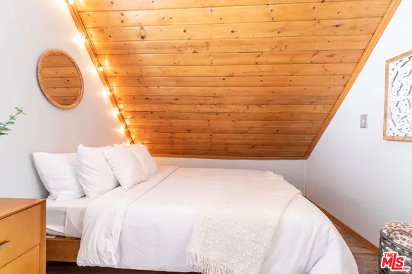 a bed room with a bed and a chair