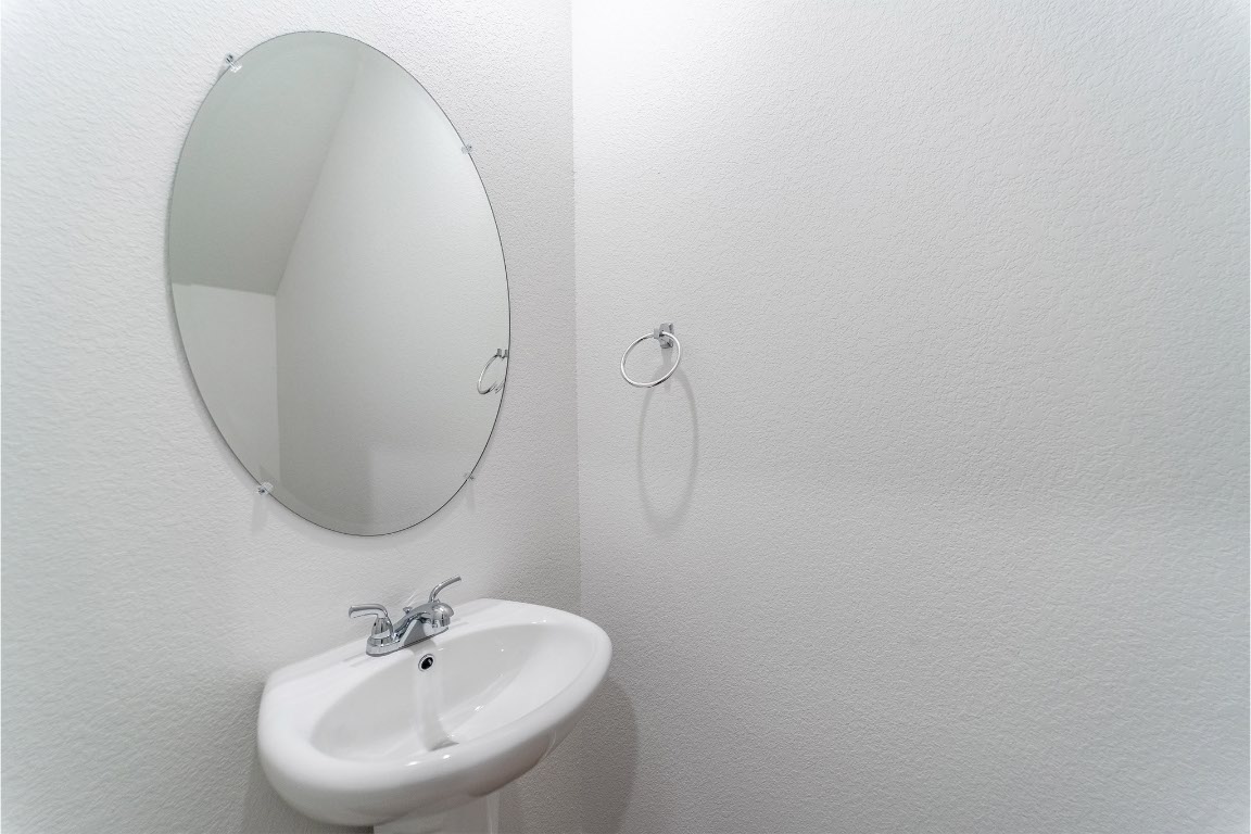 732 Barbary Coast Lane Jarrell, TX 76537 - Photo 16 of 17 a bathroom with a sink and a mirror