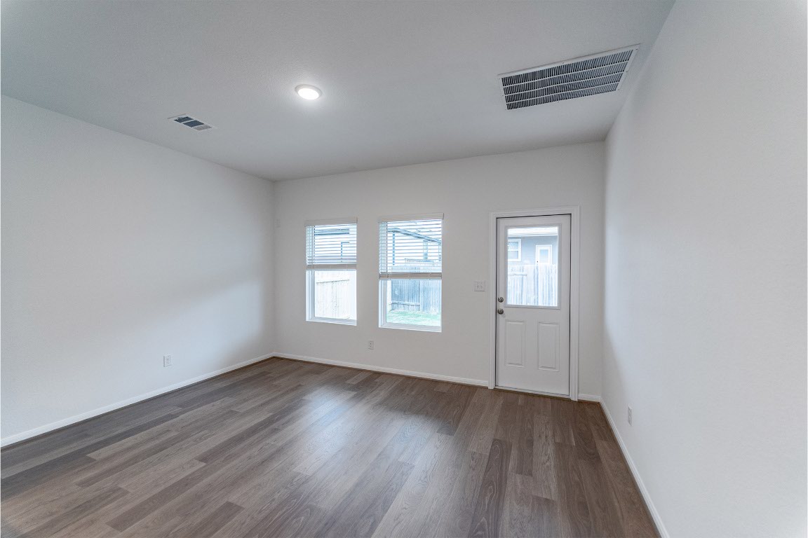 732 Barbary Coast Lane Jarrell, TX 76537 - Photo 6 of 17 an empty room with wooden floor and windows