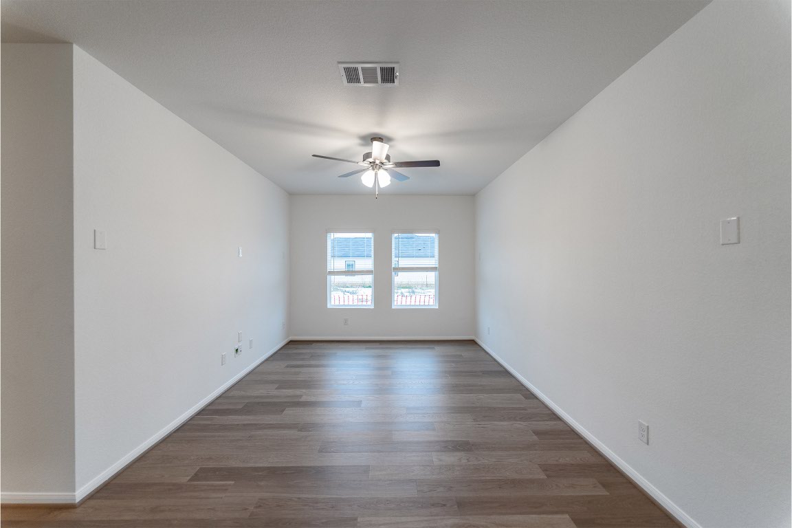 732 Barbary Coast Lane Jarrell, TX 76537 - Photo 7 of 17 wooden floor in an empty room with a window