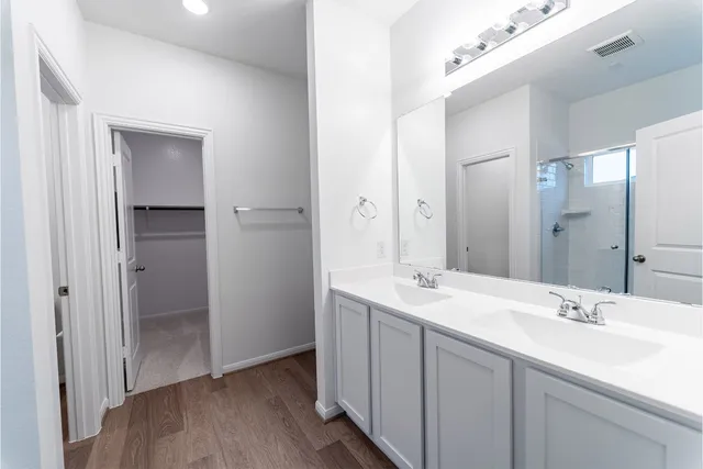 a bathroom with a double vanity sink mirror and