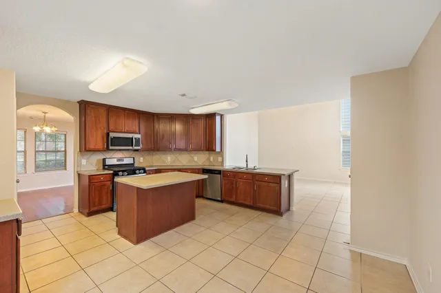 a kitchen with stainless steel appliances granite countertop a stove and a refrigerator