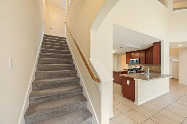 a view of an entryway with kitchen and sink