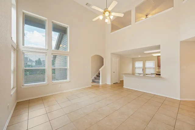 a view of a livingroom with a ceiling fan and window