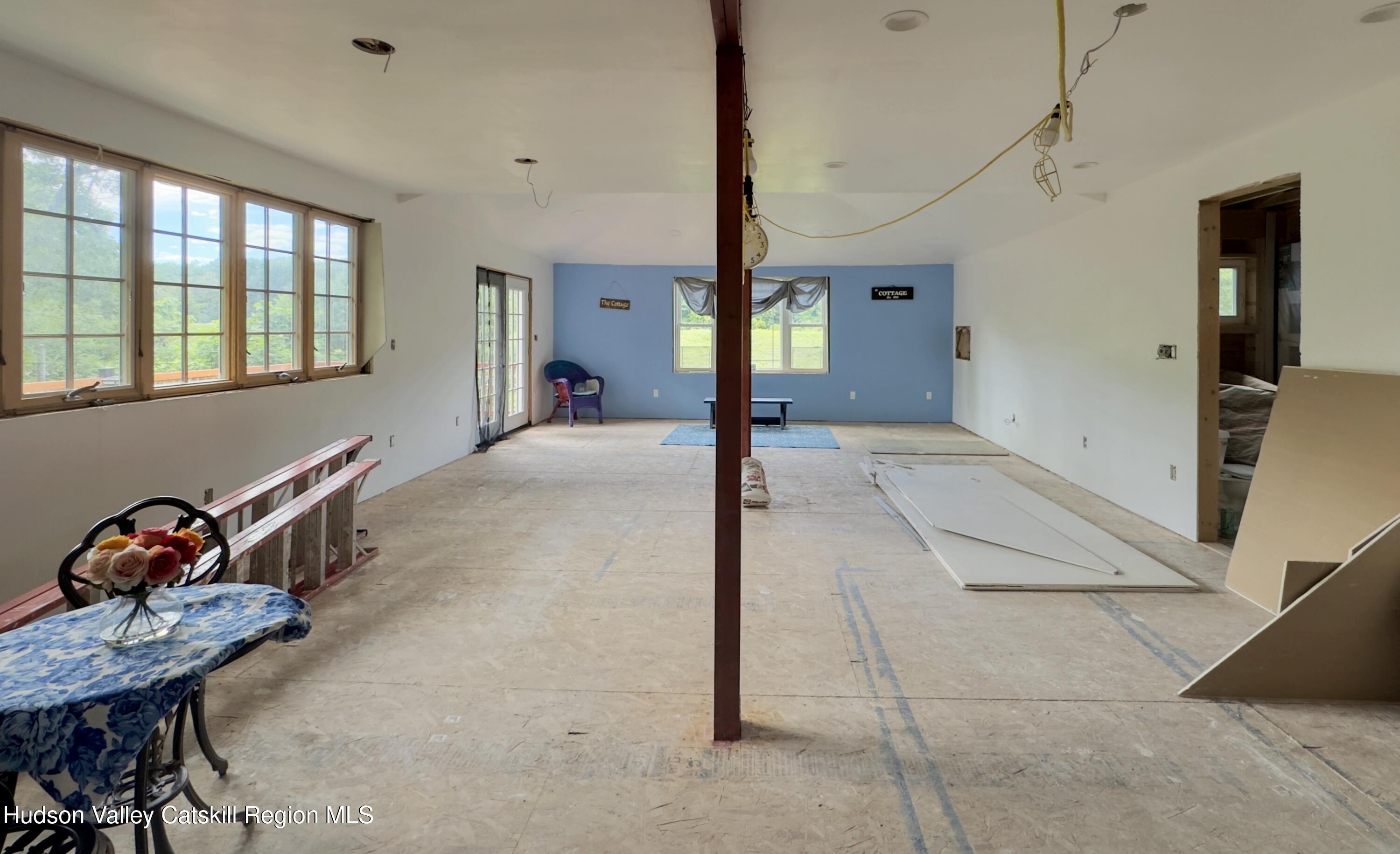 9 Old Green Lake Road Catskill, NY 12414 - Photo 5 of 12 a view of a livingroom with lounge chair and windows