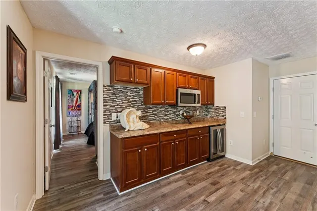 a spacious bathroom with a granite countertop sink and a mirror