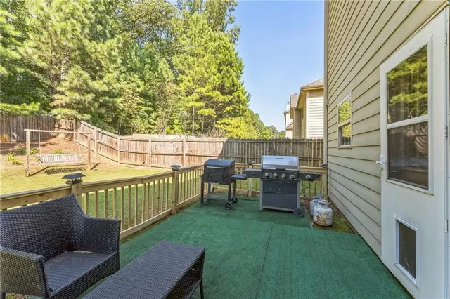 a view of a deck with chairs and a yard