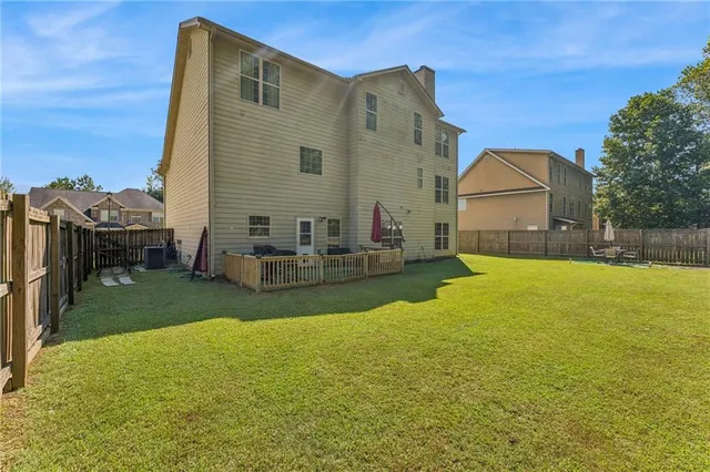 a house view with swimming pool in front of it