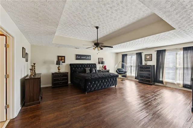 a living room with furniture fireplace and wooden floor