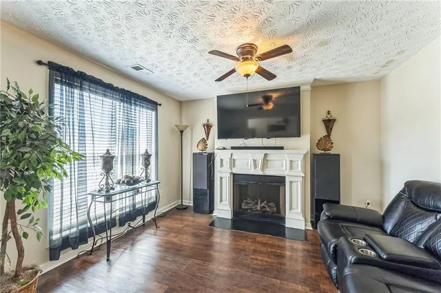 a living room with furniture a fireplace and a flat screen tv