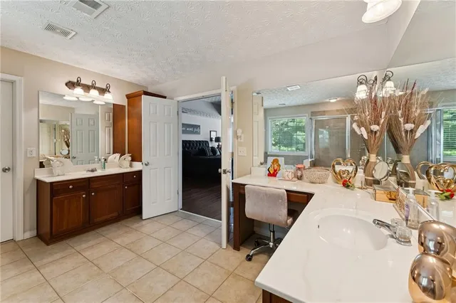 a large white kitchen with a large window and refrigerator