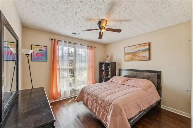 a bedroom with a large bed and a large window