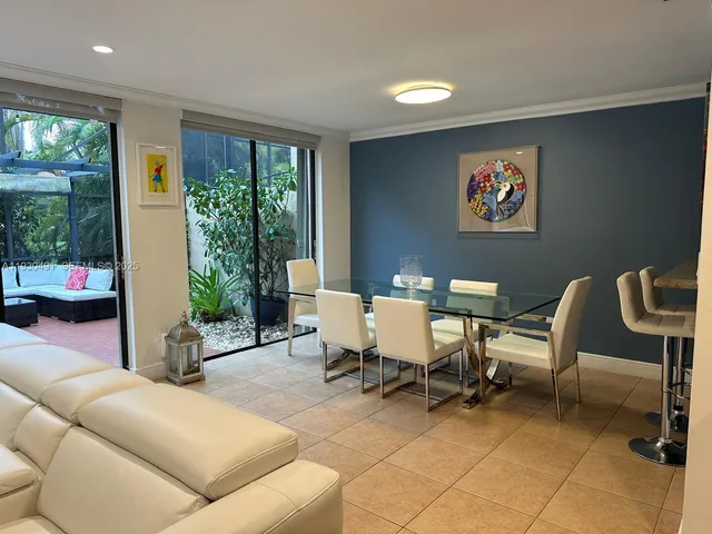 a living room with furniture a rug and a window
