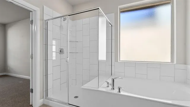 a bathroom with a tub sink and mirror