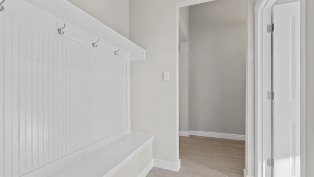a view of a hallway with wooden cabinets