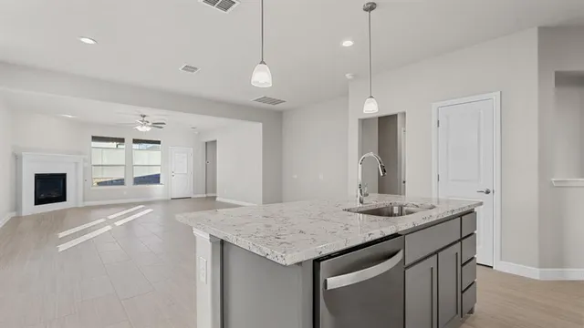 a kitchen with stainless steel appliances granite countertop a stove and a sink