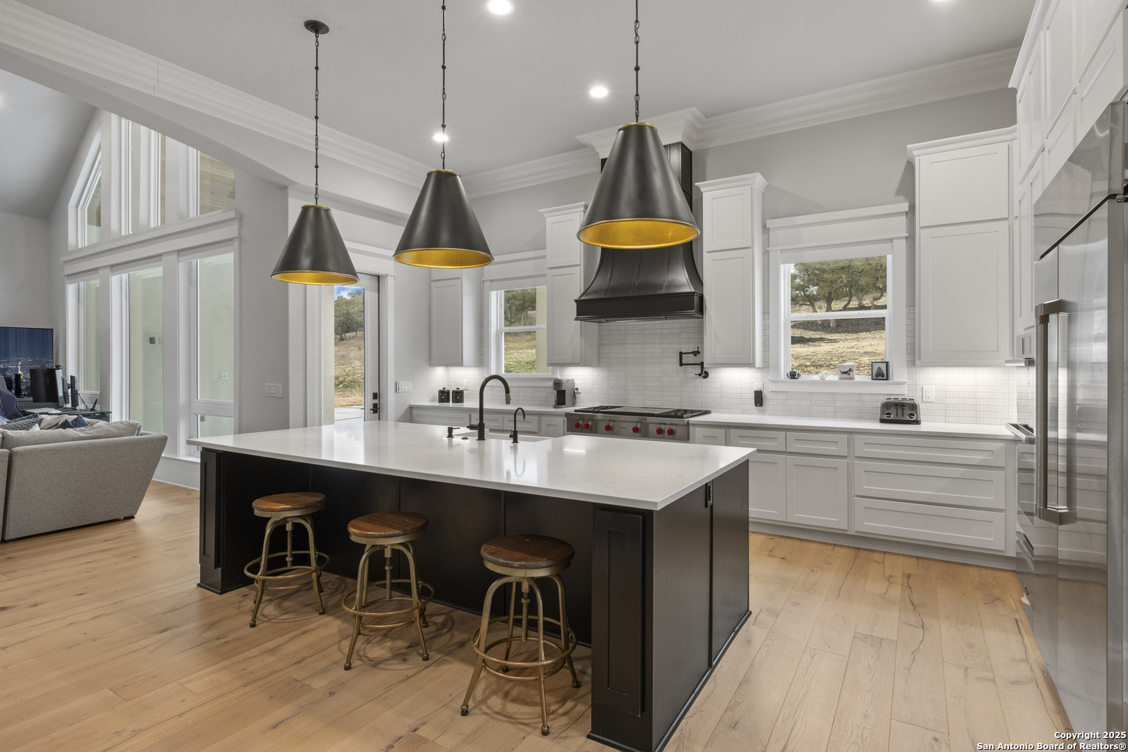 5971 Colin Ridge New Braunfels, TX 78132 - Photo 11 of 52 a kitchen with stainless steel appliances granite countertop a sink a stove and a wooden floors