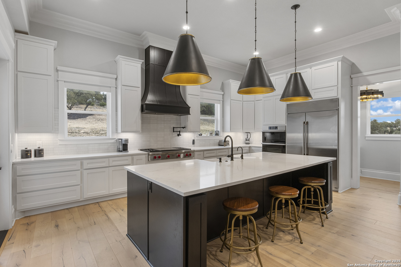 5971 Colin Ridge New Braunfels, TX 78132 - Photo 12 of 52 a kitchen with stainless steel appliances granite countertop a sink a stove and a wooden floors