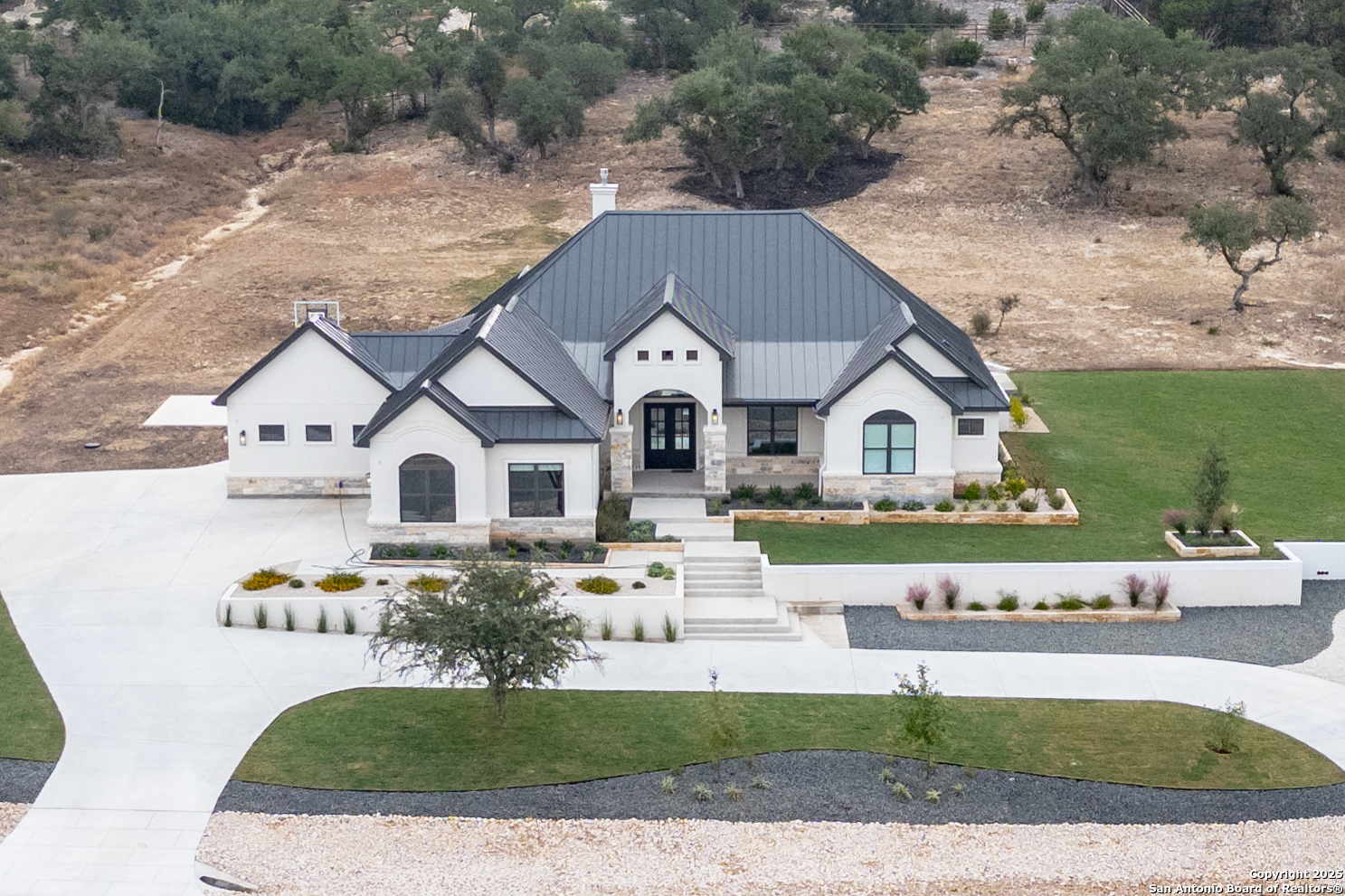 5971 Colin Ridge New Braunfels, TX 78132 - Photo 2 of 52 a front view of a house with a yard and garage