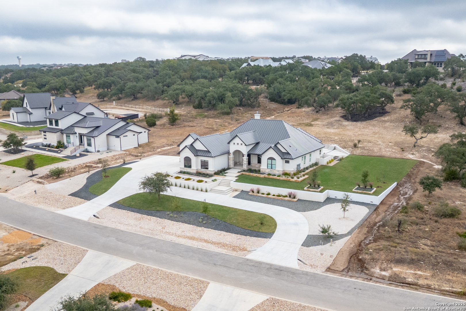 5971 Colin Ridge New Braunfels, TX 78132 - Photo 39 of 52 an aerial view of a house with a garden and mountains