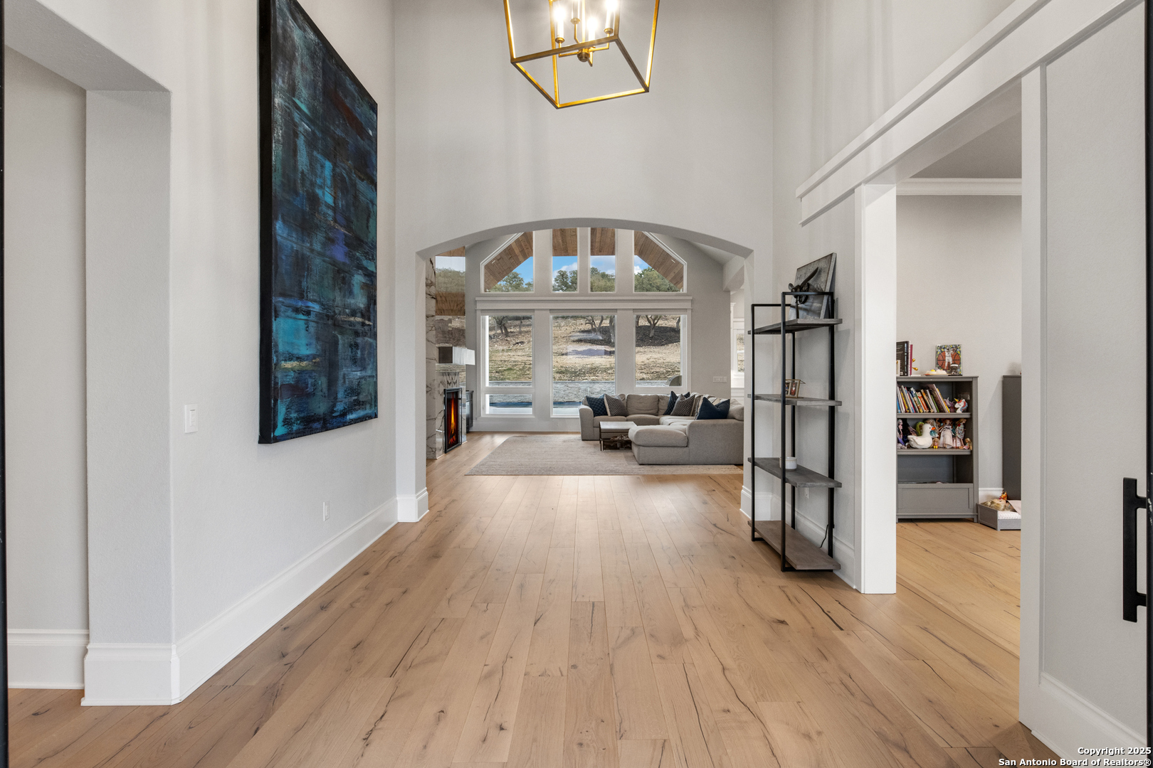 5971 Colin Ridge New Braunfels, TX 78132 - Photo 7 of 52 a view of a hallway with wooden floor and fireplace