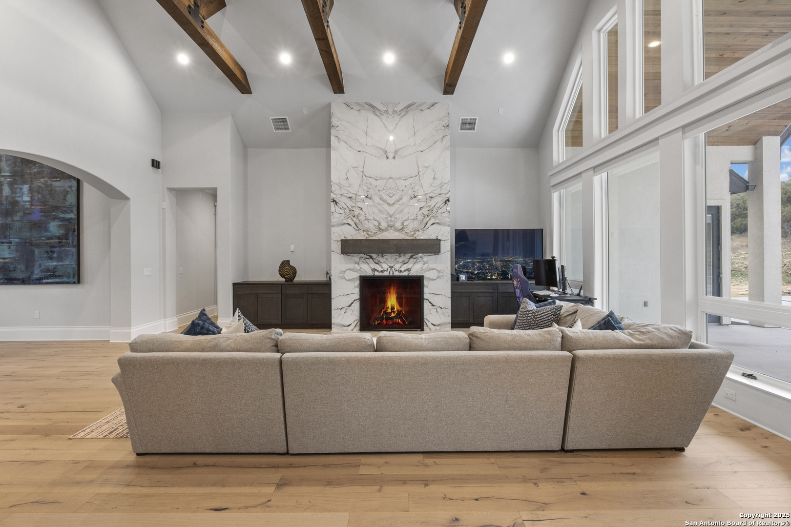 5971 Colin Ridge New Braunfels, TX 78132 - Photo 9 of 52 a living room with furniture a fireplace and a chandelier