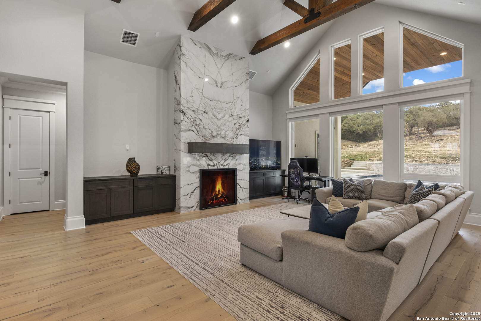 5971 Colin Ridge New Braunfels, TX 78132 - Photo 10 of 52 a living room with furniture a fireplace and a large window
