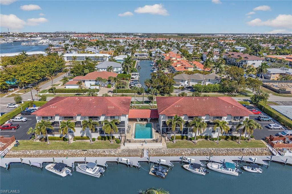 1400 Blue Point Avenue, Unit 202 Naples, FL 34102 - Photo 1 of 18 an aerial view of residential houses with outdoor space