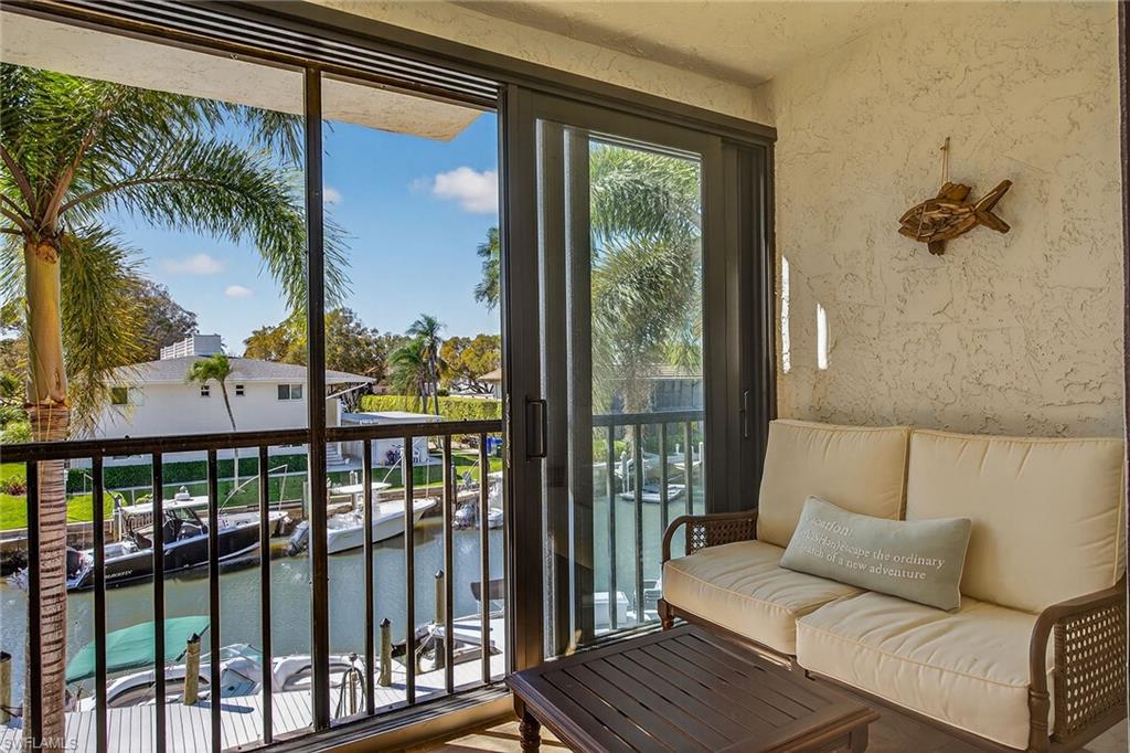 1400 Blue Point Avenue, Unit 202 Naples, FL 34102 - Photo 13 of 18 a living room with furniture and a large window