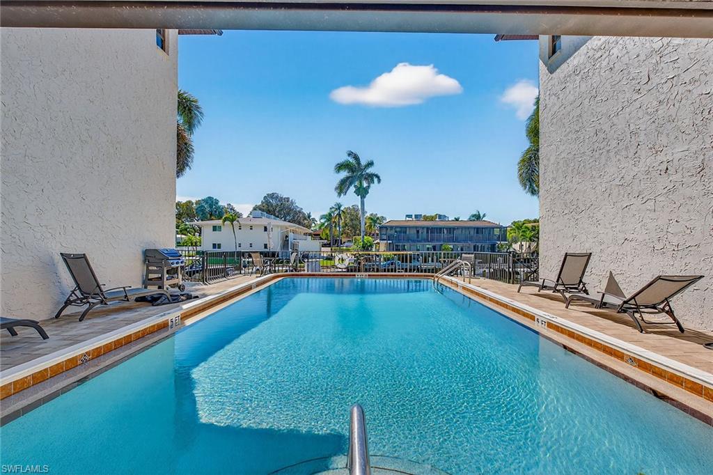 1400 Blue Point Avenue, Unit 202 Naples, FL 34102 - Photo 14 of 18 a view of a kitchen with a large pool and sitting area