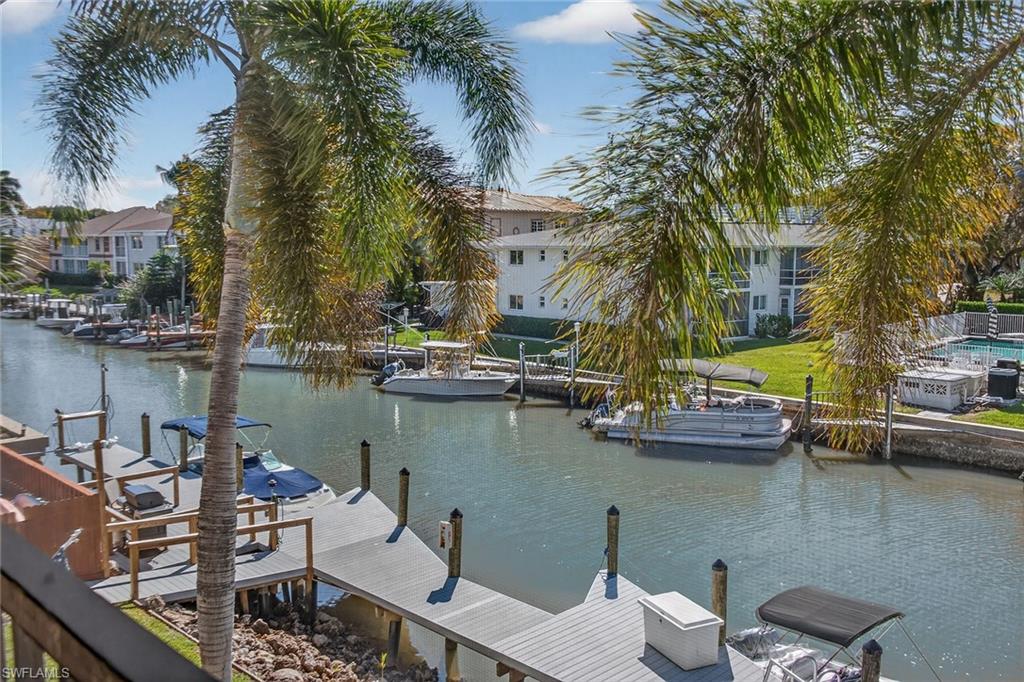 1400 Blue Point Avenue, Unit 202 Naples, FL 34102 - Photo 15 of 18 a view of a lake with sitting area