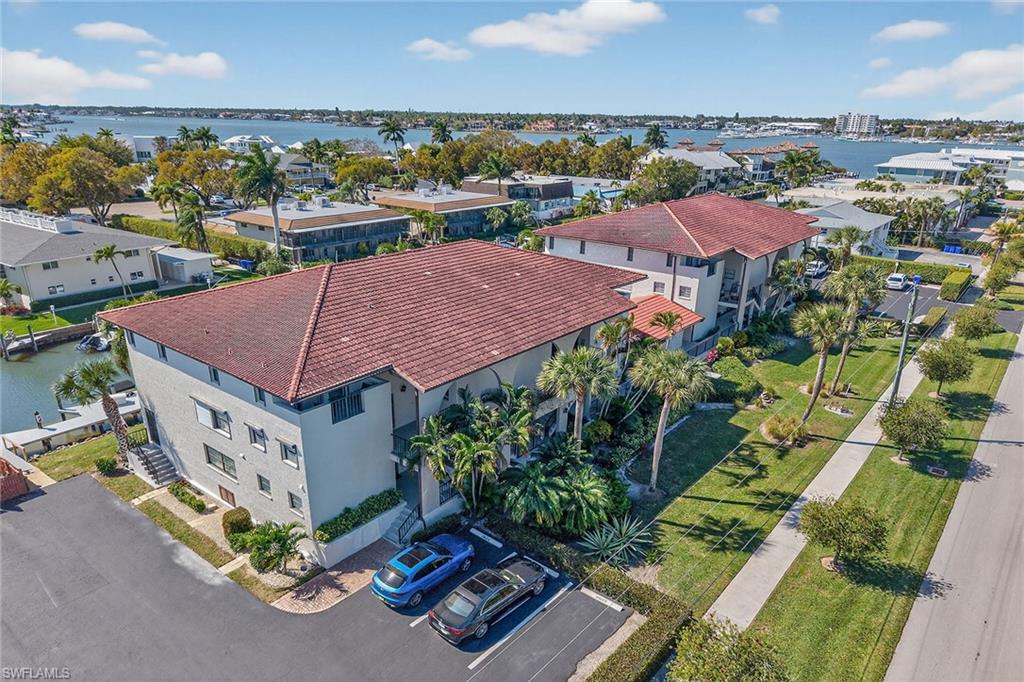 1400 Blue Point Avenue, Unit 202 Naples, FL 34102 - Photo 16 of 18 an aerial view of multiple houses with yard