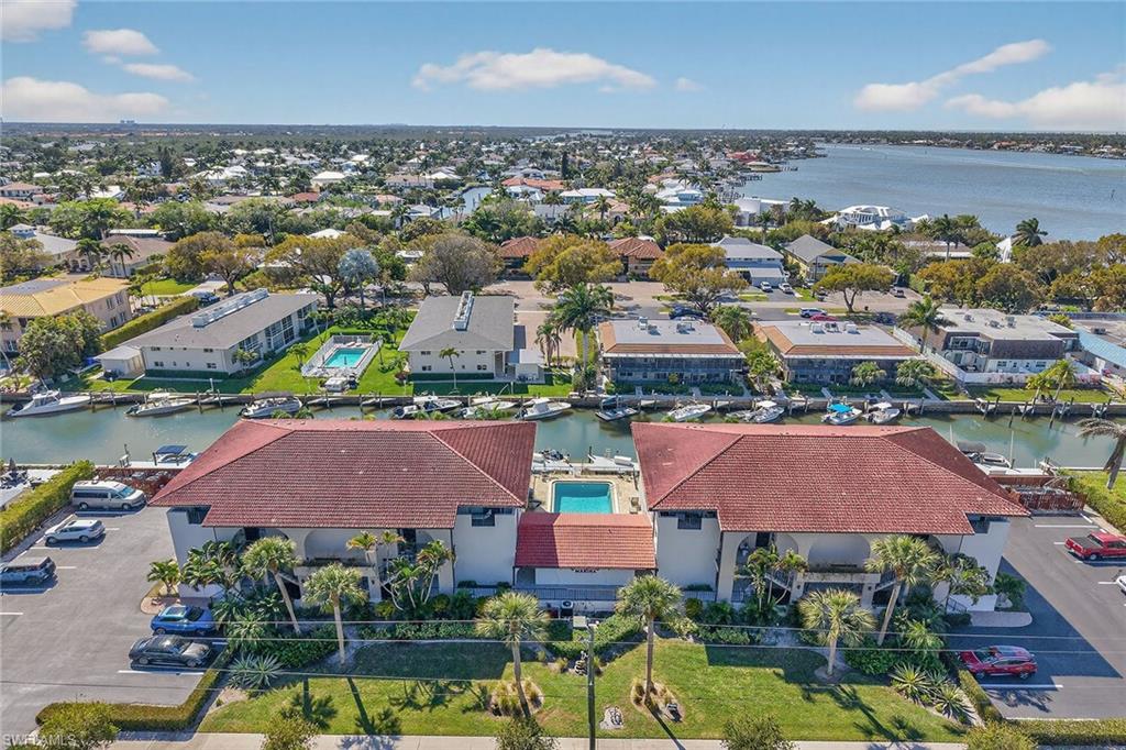 1400 Blue Point Avenue, Unit 202 Naples, FL 34102 - Photo 17 of 18 an aerial view of residential houses with outdoor space and lake view