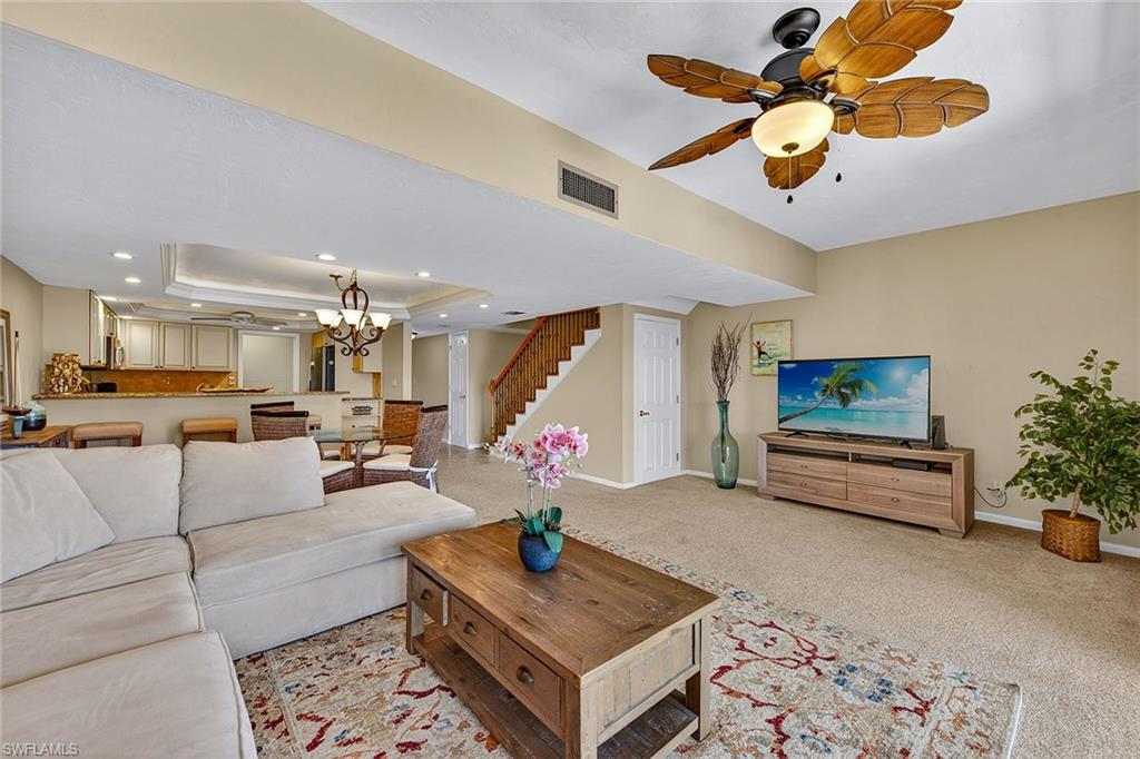 1400 Blue Point Avenue, Unit 202 Naples, FL 34102 - Photo 4 of 18 a living room with furniture and a flat screen tv