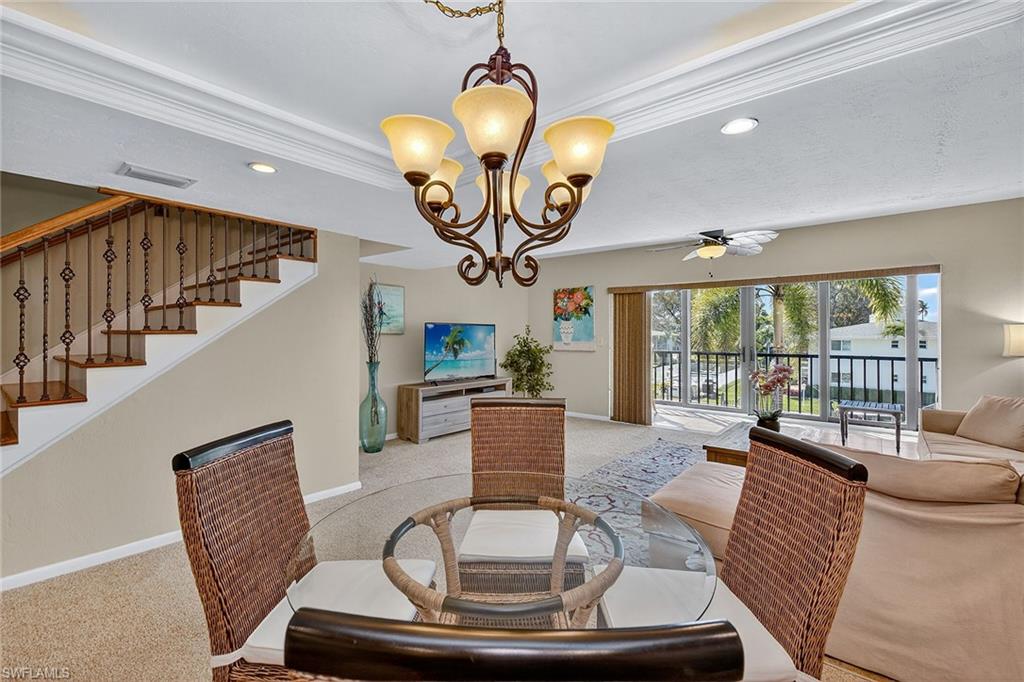 1400 Blue Point Avenue, Unit 202 Naples, FL 34102 - Photo 5 of 18 a living room with furniture and a large window