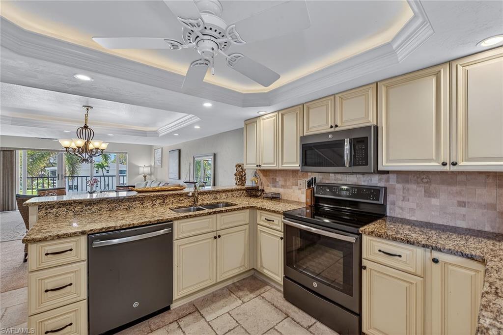 1400 Blue Point Avenue, Unit 202 Naples, FL 34102 - Photo 7 of 18 a kitchen with stainless steel appliances granite countertop a sink and cabinets