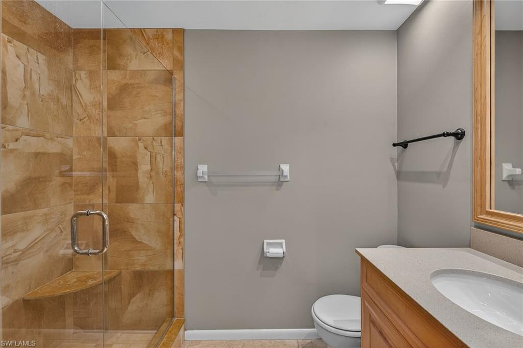 1400 Blue Point Avenue, Unit 202 Naples, FL 34102 - Photo 10 of 18 a bathroom with a granite countertop sink toilet and shower