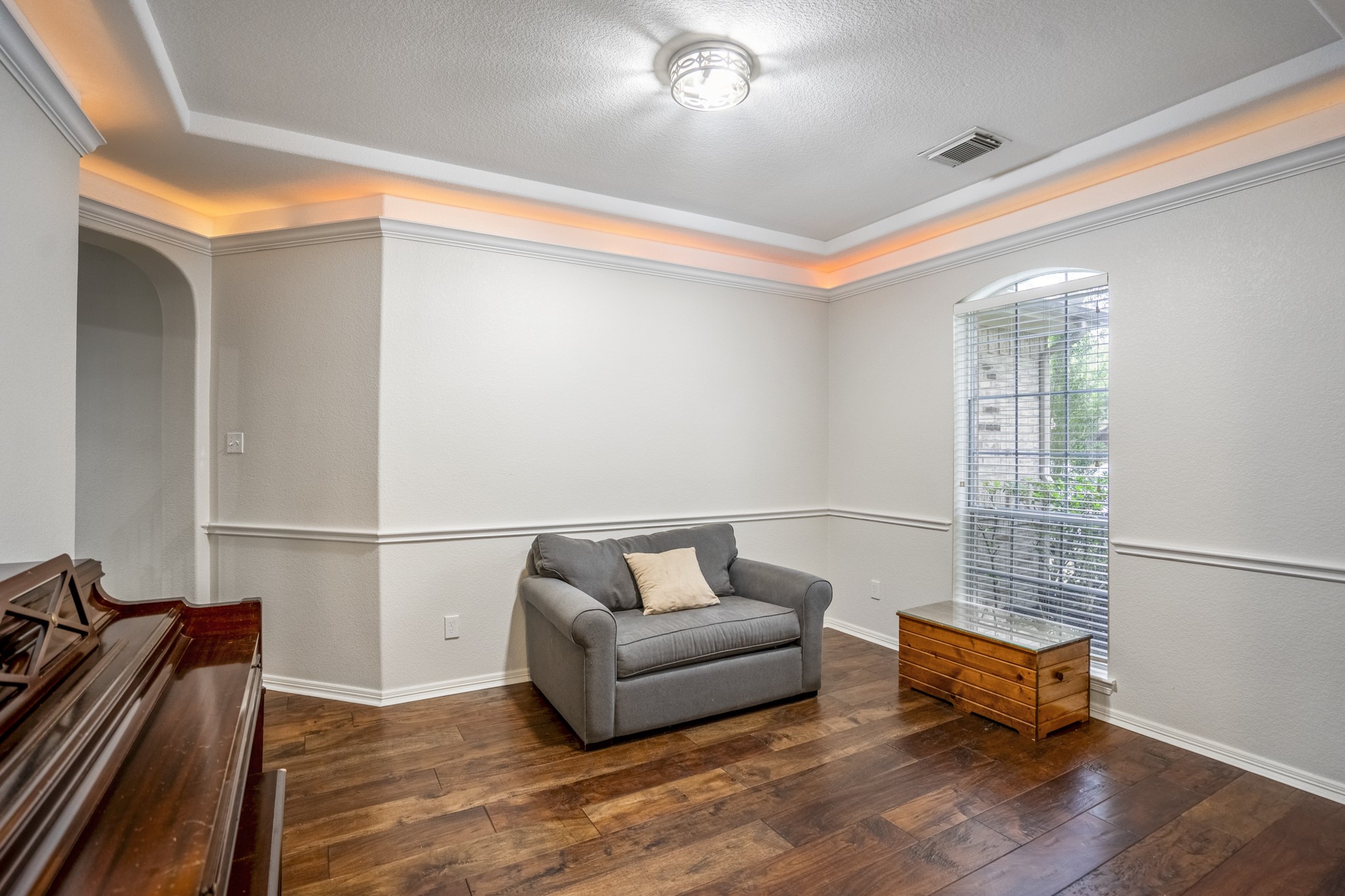 10410 Pitcataway Drive Spring, TX 77379 - Photo 8 of 48 The formal dining room has rope lighting and also a nice sized arched window, chair rail, crown molding and hand scraped wood floors.