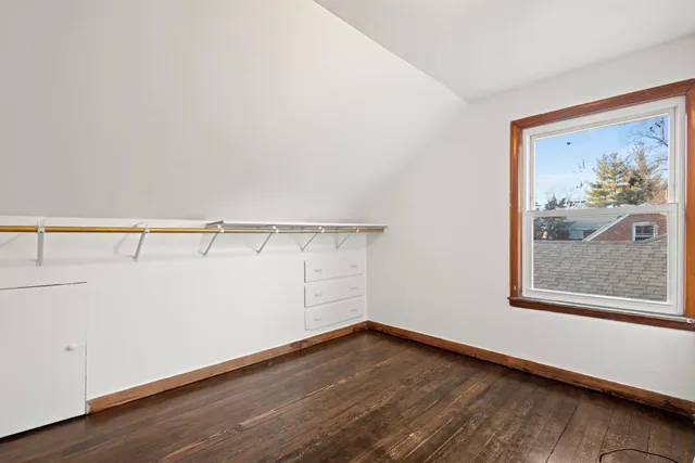 a view of a room with wooden floor and cabinet