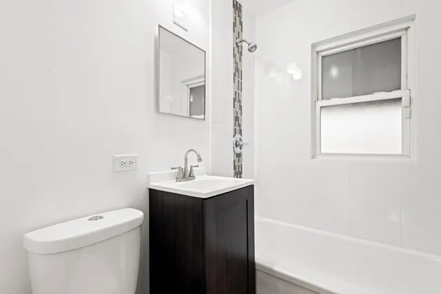 a bathroom with a sink a toilet and vanity