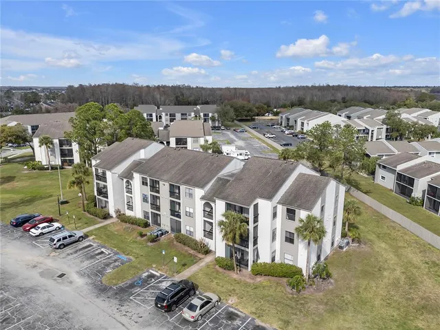an aerial view of multiple houses with a yard