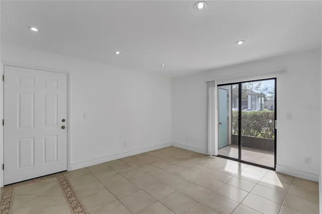 a view of an empty room with glass door