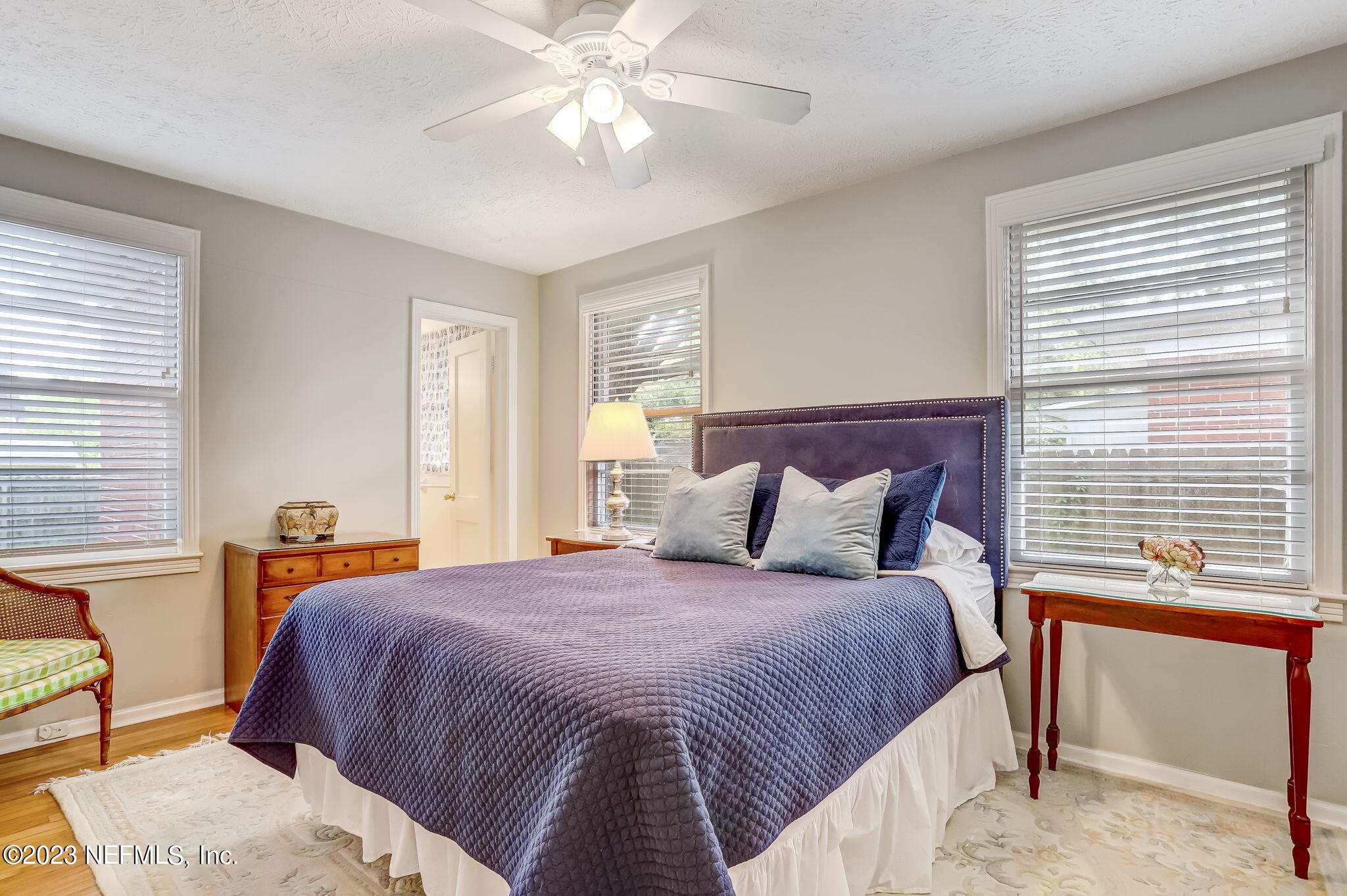 4375 Timuquana Road Jacksonville, FL 32210 - Photo 17 of 24 a bedroom with a bed and a chandelier