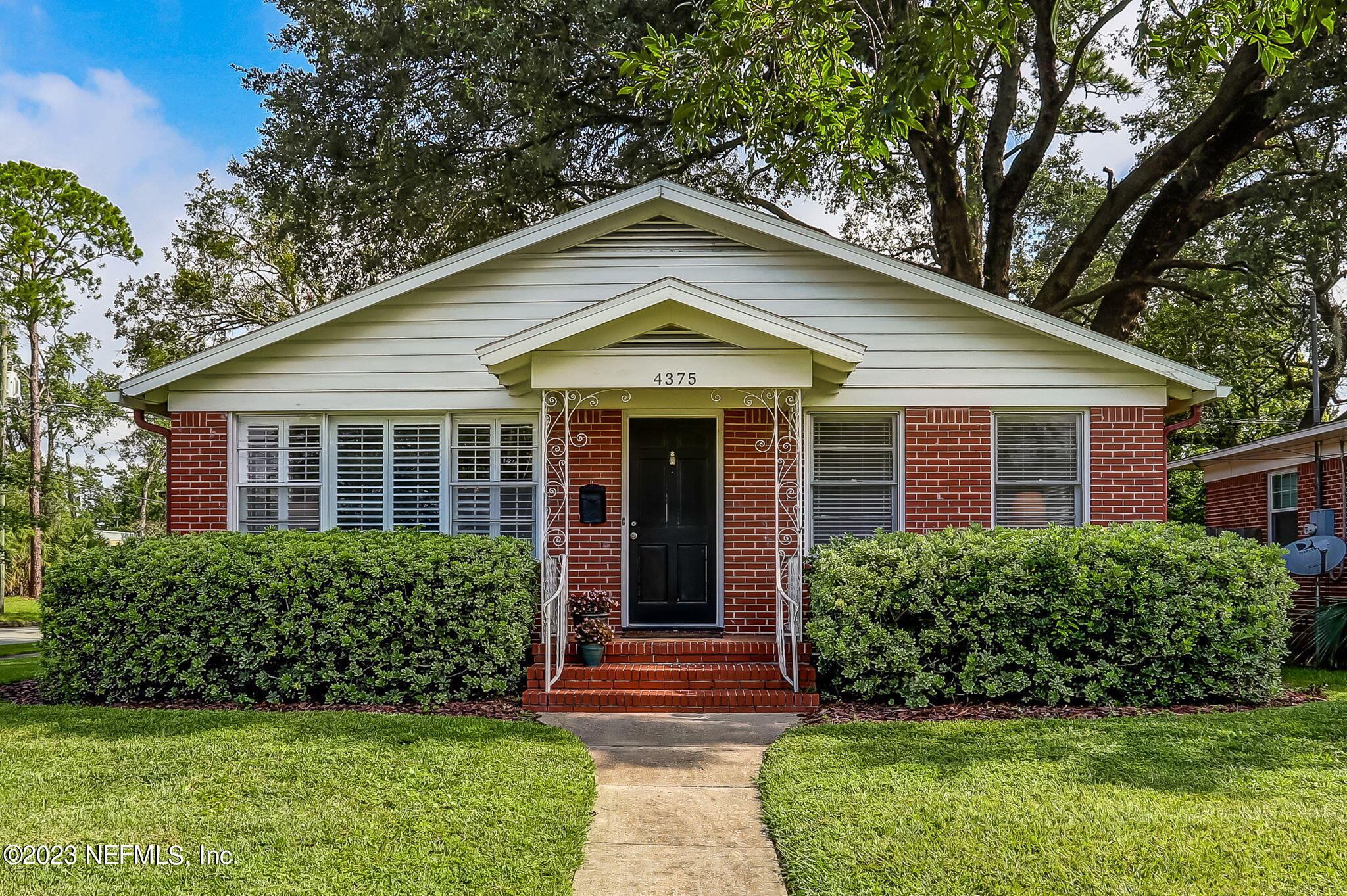 4375 Timuquana Road Jacksonville, FL 32210 - Photo 3 of 24 a front view of a house with a yard