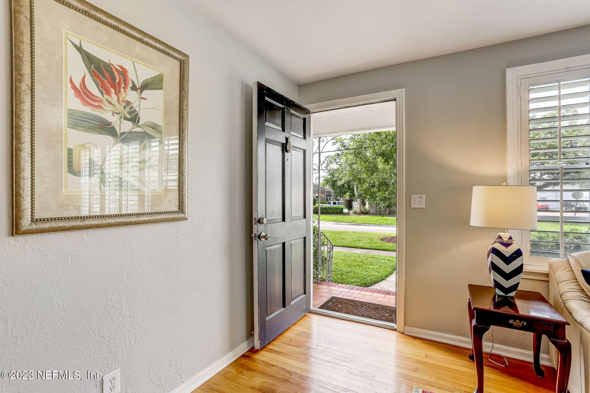 4375 Timuquana Road Jacksonville, FL 32210 - Photo 7 of 24 a hallway with a wooden floor and a bookshelf