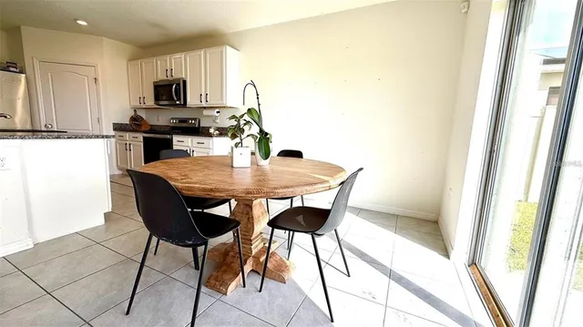 a kitchen with a dining table and chairs