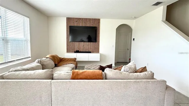 a living room with furniture and a flat screen tv