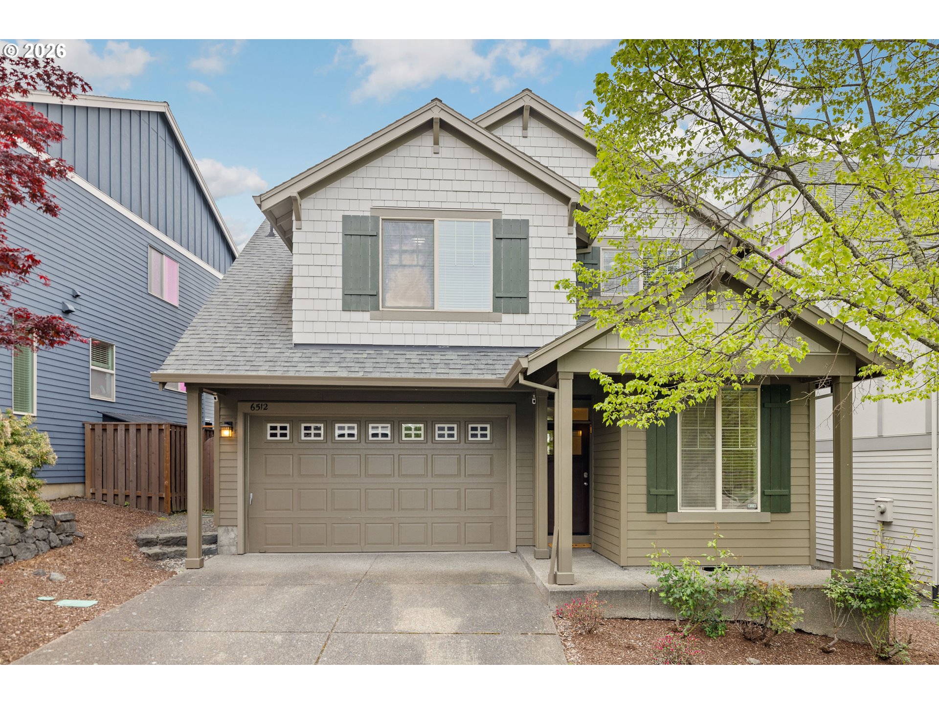 6512 Northwest 165th Avenue Portland, OR 97229 - Photo 1 of 42 a front view of a house with a garden